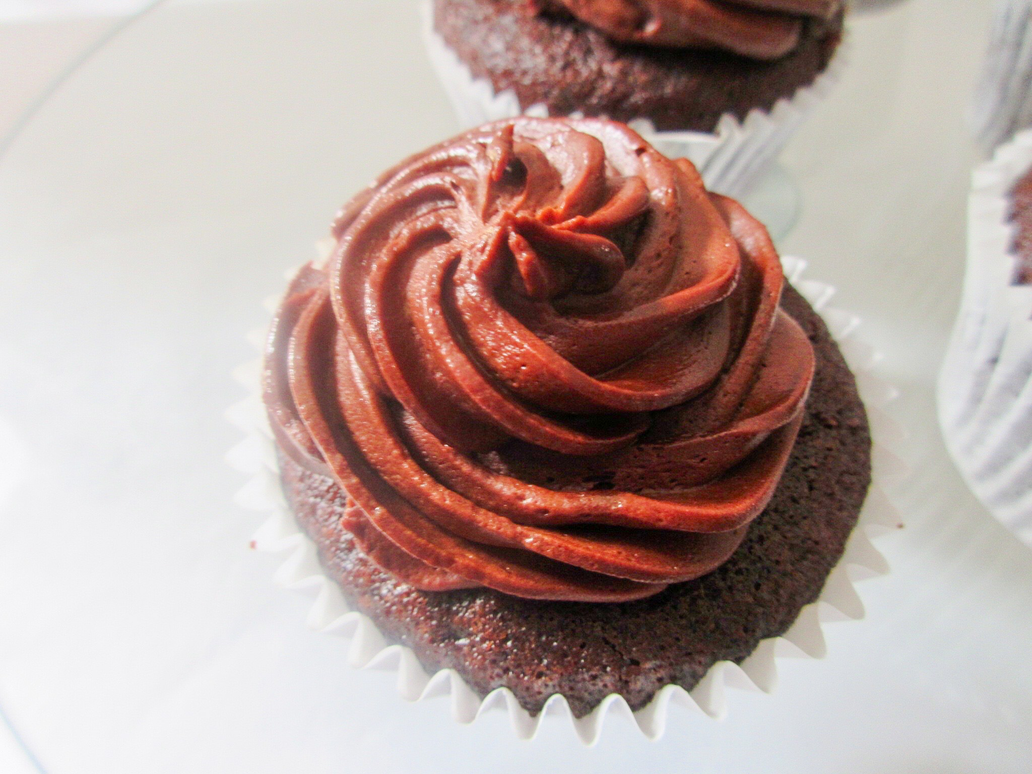 Chocolate ganache cupcake from a top view.