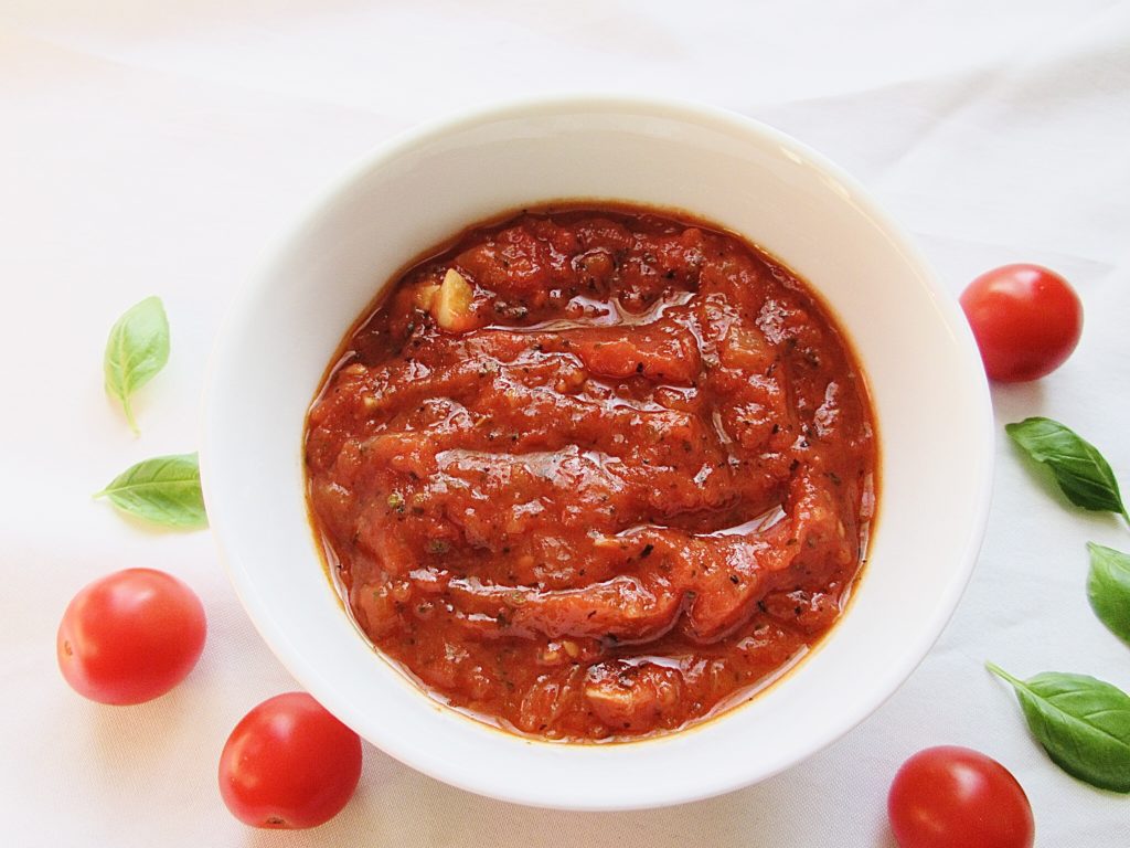 Marinara sauce in a white bowl.