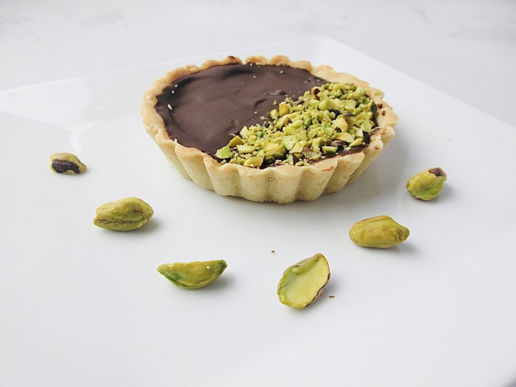 Chocolate ganache tarts with pistachio nuts