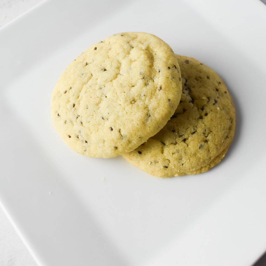 2 lemon ginger chia cookies on a white plate.
