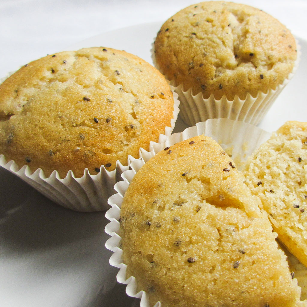 3 lemon chia muffins on a plate.