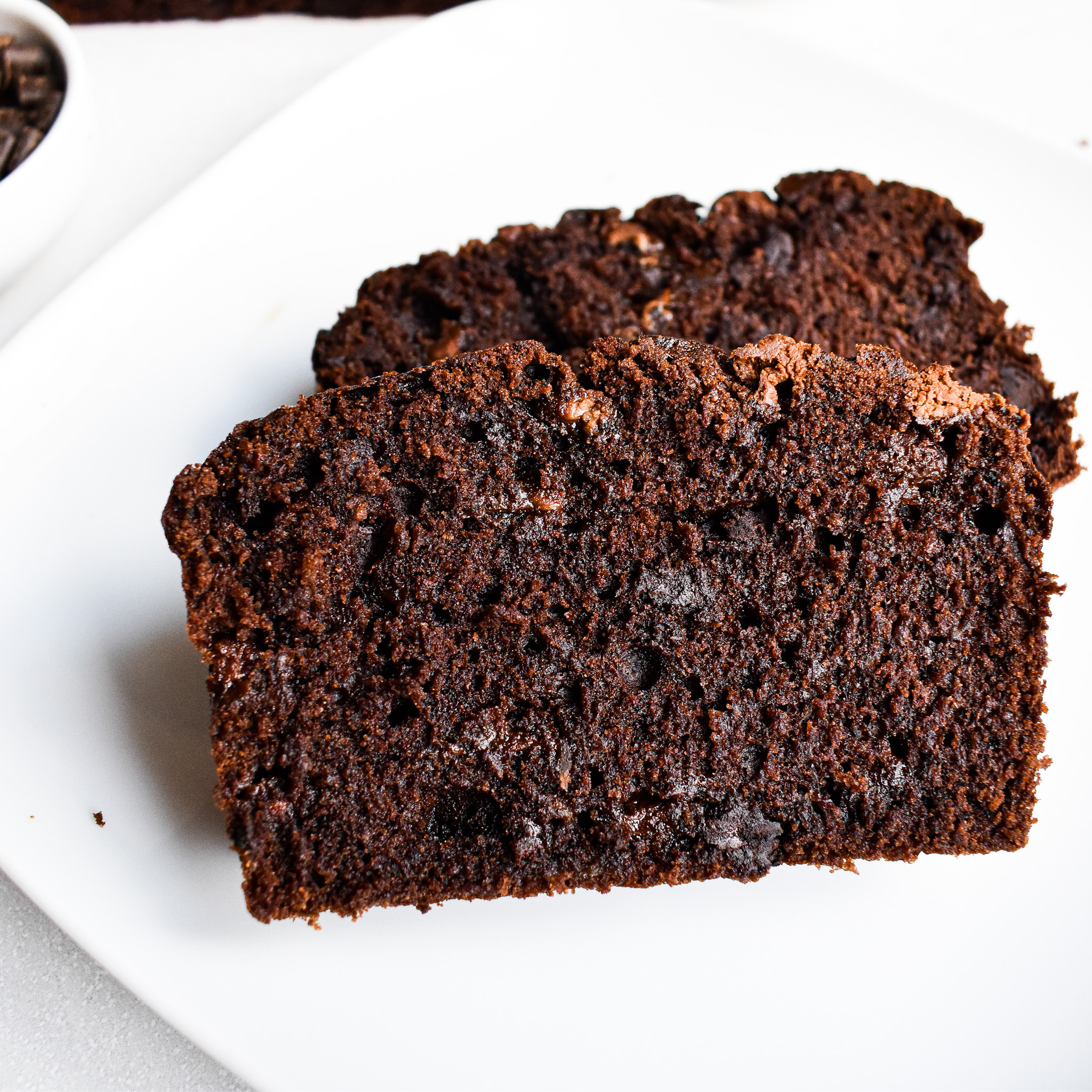 Double chocolate banana loaf cake slices on plate.