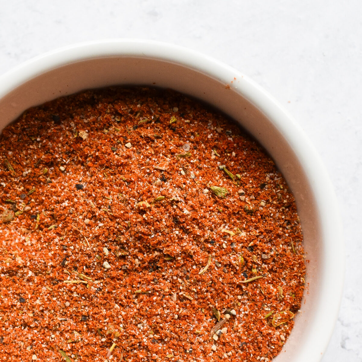 Cajun seasoning in white bowl.