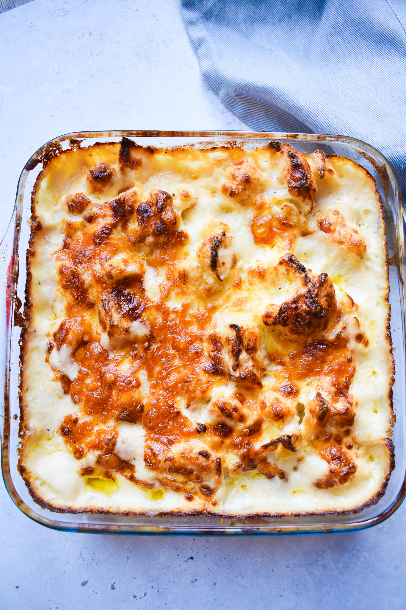 Creamy cauliflower cheese in clear roasting dish