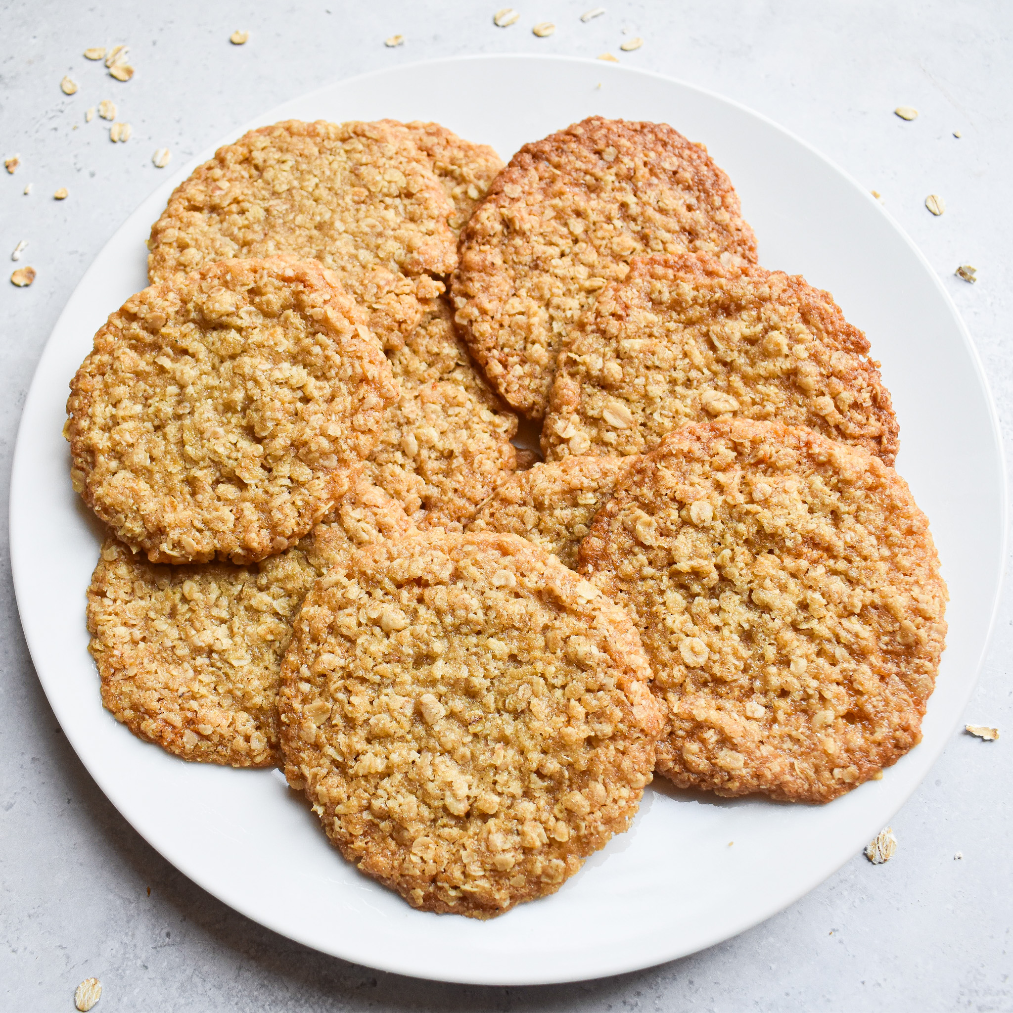 Oat lace cookies on plate from top view.