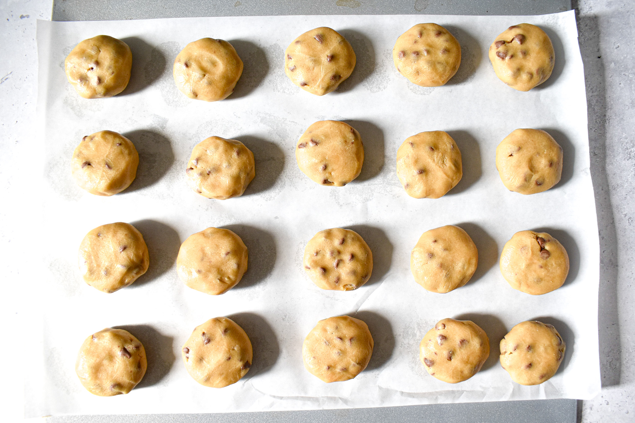 unbaked cookies on a baking tray.