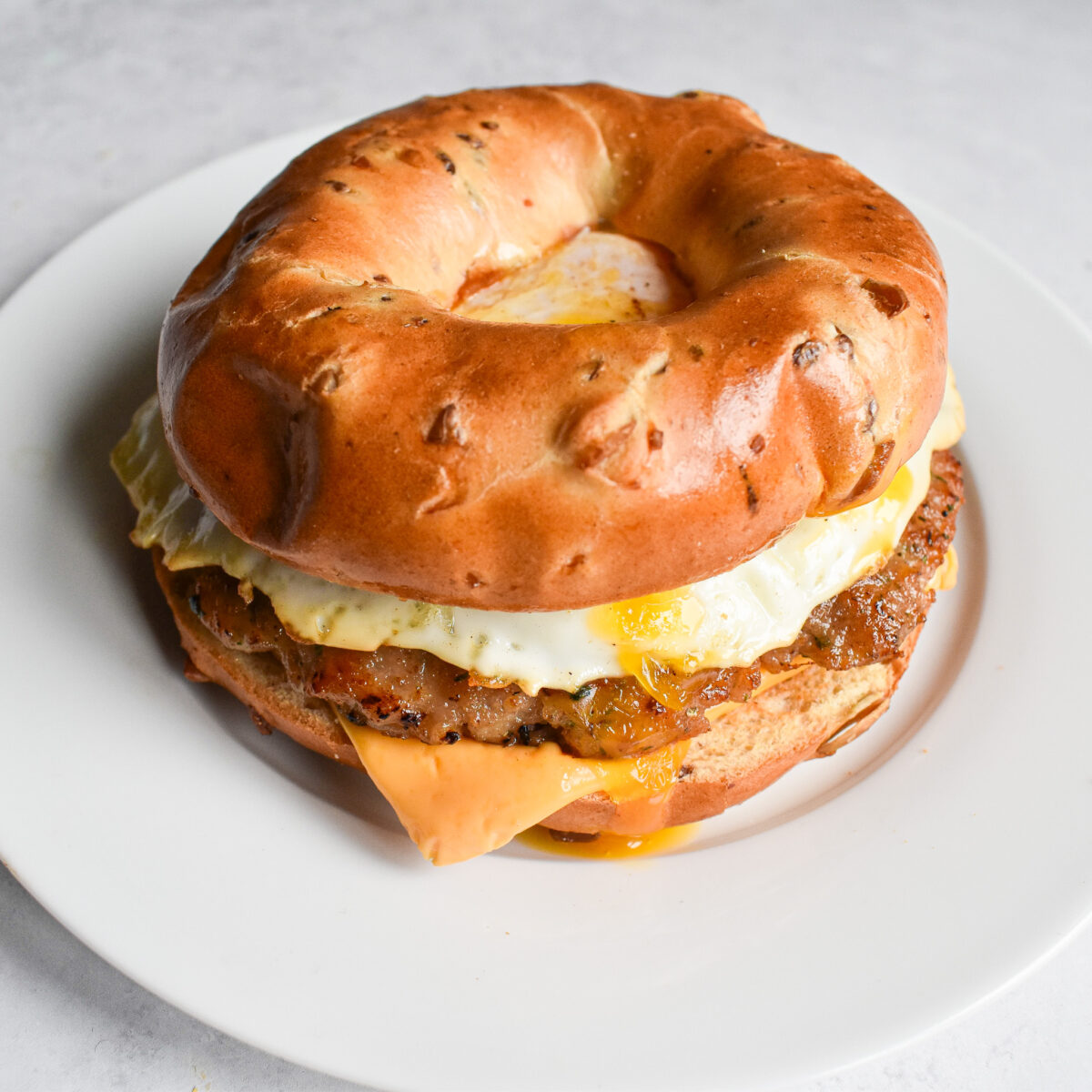 sausage patties in bagel with egg.